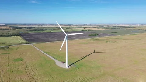 Left-to-right aerial orbit of a modern wind turbine generating clean energy. Stock Footage 316637912