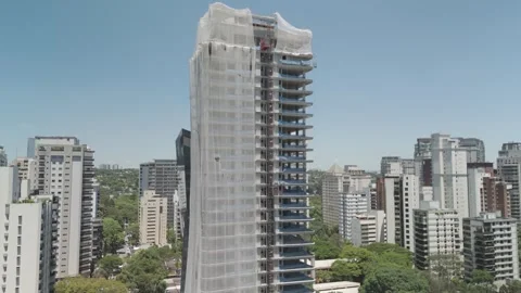 Left-to-Right Aerial Pan of Skyscraper Under Construction Structure Stock Footage 322080680