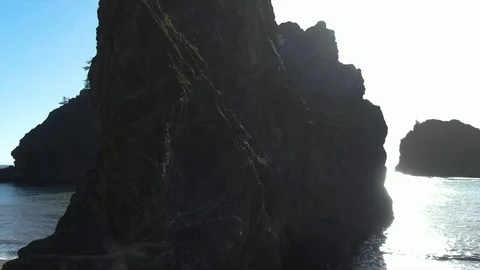 Left to right dolly shot passing a tiny rock formed island on the Oregon Video stock 120387640