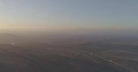 Left to Right Drone Flight Toward Wind Farm with Cars Below, Russia Vídeo Stock 344035276