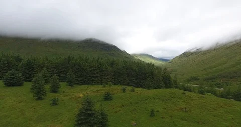 Left to Right Drone Shot of Green Scottish Hills in Morning Fog 動画素材 97592189