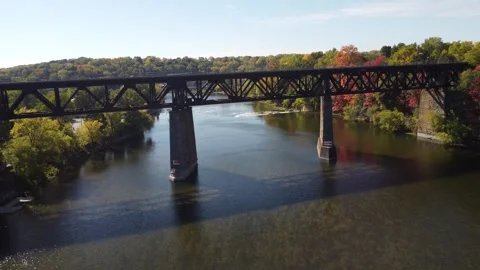 Left to Right Drone of Water, Bridge &amp; Train Track Stock Footage 314202066