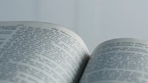 Left to right movement on Bible opened on Psalms Stock Footage 124761230