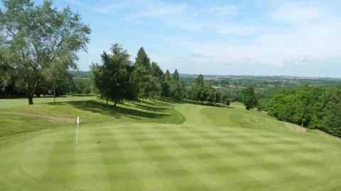 Left to right pan across a golf putting green Stock Footage 288011777