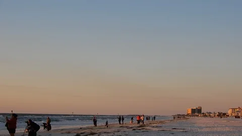 Left To Right Pan Of Beach Resort Buildings At Sunset To People Photographer Stock Footage 127250245