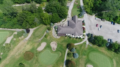Left To Right Pan Over Golf Clubhouse With Golf Greens By Forest Stock Footage 121174982