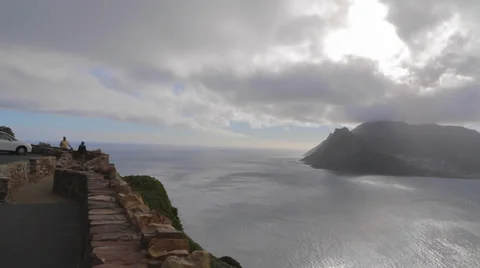 A left to right pan at  pretty camps bay mountain and blue water Stock Footage 36487009