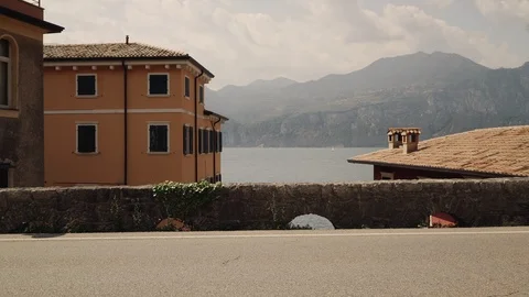 Left to right pan real time establishing shot of a beautiful house on lake Garda Stock Footage 122287642
