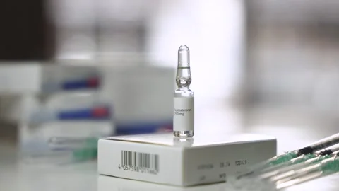 Left to Right Pan Revealing Syringes Beside Testosterone Ampoule Stock Footage 327477392