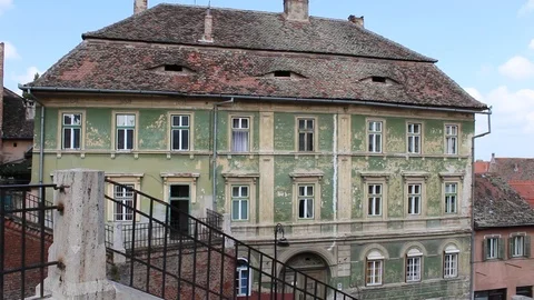 Left-Right pan view of green house and others with eyes in the roof Stock Footage 97845640