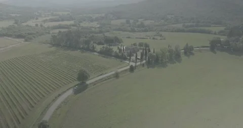 Left to Right Panoramic Drone Flight Over Tuscan Villa, Road and Hills in Italy Stock Footage 343932547