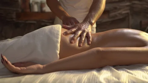 Left to right shot of a masseur performing back and shoulders massage to the Stock Footage 120067170