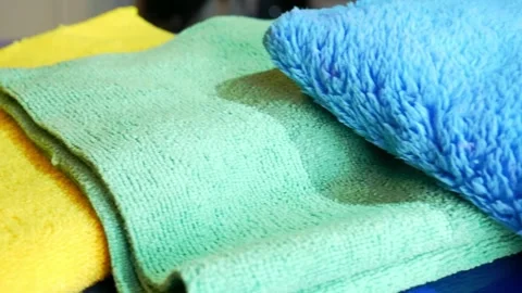 Left to right sliding shot of various microfiber towels in yellow, green and Stock Footage 321069140