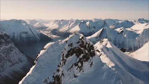 Left to right tilt of two summiters on steep mountain Stock Footage 99839047