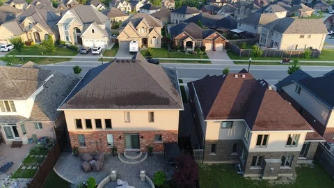 Left to Right Tracking Shot of New Homes With Backywards in Early Morning Su Stock Footage 124489475