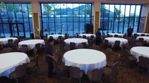 Left to right tracking shot as staff fixes tables Stock Footage 136952784