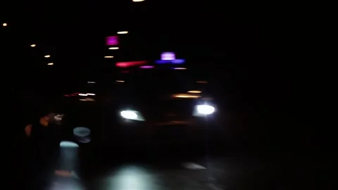 Left side car mirror showing police car in motion. Soft blur of a police car Video stock 146913319