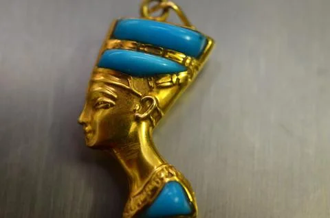 Left side gold bust of queen Nefertiti the wife of the Pharaoh Akhenaten, d.. Stock Photos