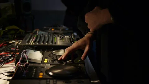 Left side of person using hands for tweaking and adjusting knobs and fader 動画素材 171111925