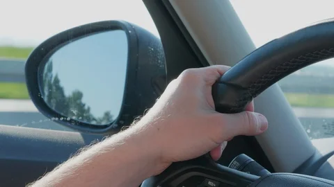 Left side rear view mirror and steering wheel at car driving Stock Footage 109062546