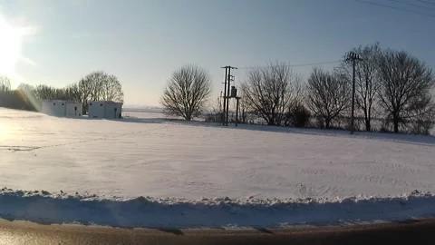 Left side road video view on snowy sunlit landscape in lowlads of Slovakia. Видео 331317994