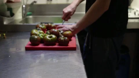 Left side view of a chef cleaning tomatoes Stock Footage 137945821