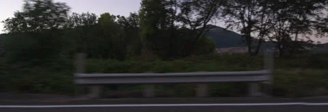 Left Side view of a Driving Plate: Car travels at dusk past farms and vineyards Stock Footage 59329935