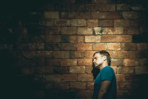 Left side view man under life crisis problems stand wearily leaned head against Stock Photos