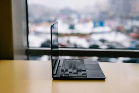 Left side view of Modern slim design laptop with black keyboard, blank screen Stock Photos