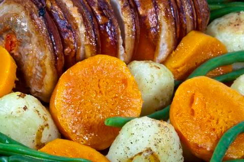 Left side view of roasted pork and vegetables Stock Photos