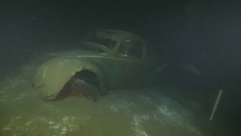 Left side of a Volkswagen Beetle wreck underwater with a diver,Albano Lake,Italy Stock Footage 224274288