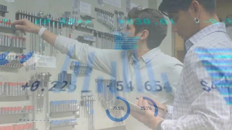 Left tech pointing at pegboard starting data overlays, right tech logging pick Stock Footage 333967843