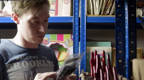 Left Tracking shot of Man Picking Paintbrushes Stock Footage 62680234