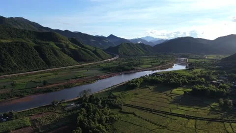 Left turning drone flight over river valley and farmland in Da Nang Vietnam Stock Footage 337948295