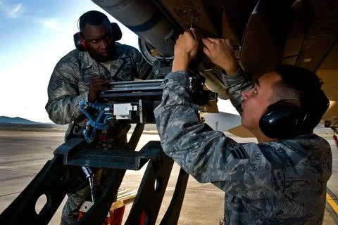 From left, U.S. Air Force Staff Sgt. Chris Sims and Senior Airman Phillip ... Stock Photos