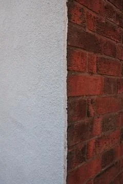 Left wall side white render right side brick and concrete Foto stock