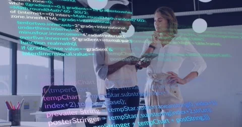 Left woman tapping tablet and explaining tech in office, animated code overlay Stock Footage 332281394