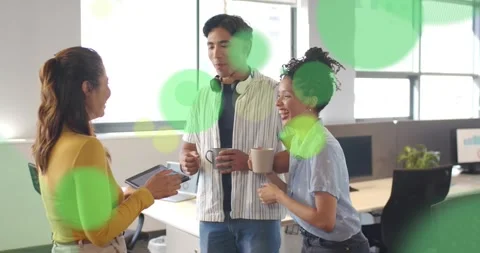 Left woman tapping tablet generating yellow green circles, office team holding Stock Footage 334031318