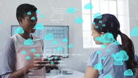 Left woman tapping tablet, sparking animated cloud icons and code over scene, Stock Footage 333975812