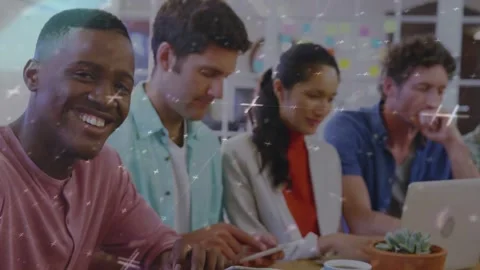 Leftmost coworker tapping tablet, then looking up noticing camera while sparkles Stock Footage 334316334
