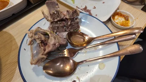 Leftover Beef Rib Bones on Dirty Plate in Bangkok Restaurant Stock Footage 342690267