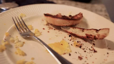Leftover breakfast on a plate with toast and scrambled eggs Stock Footage 335038694