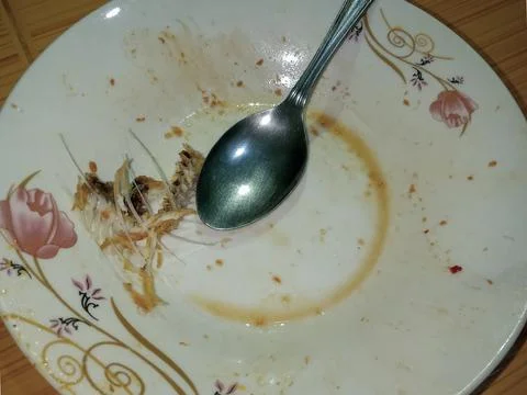 Leftover fish bones and dirty spoon. Foto stock