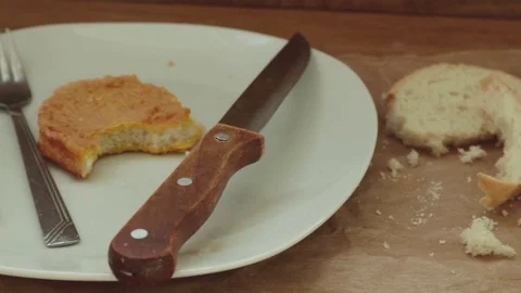 Leftovers and bread crumbs in white plate Stock Footage 80350763