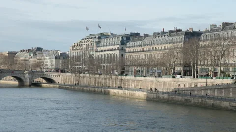 Leftward camera pan from Pont Neuf toward La Samaritaine at sunset Stock Footage 323912684