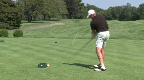 Lefty golfer driving ball down fairway Stock Footage 32326496