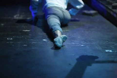 The leg of a dancer doing stretching on the floor of a rehearsal room Stock Photos