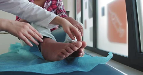 Leg Dislocation First Aid. Doctor Examines Knee Of African American Girl Stock Footage 146539771