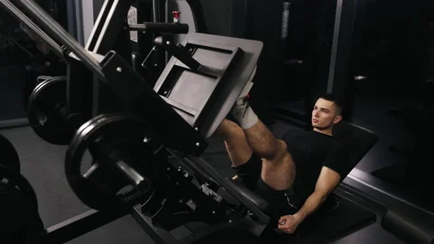 Leg press, Machine workout, Athletic man Stock Footage 237465913