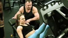 A young woman exercising, doing the leg press.. A fit young woman